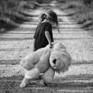 grayscale photography of girl holding plush toy